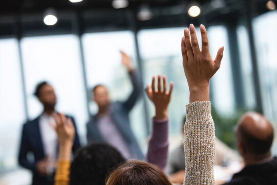 Asian man actively participating by raising hand to ask questions in seminar, conference, or training, engaged audience interaction, professional meeting environment
