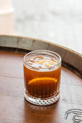 Clear fresh cocktail in a glass on the street on a sunny day