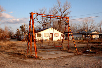 Fototapeta premium Rusty Swing Set Behind a Diner