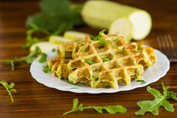Homemade zucchini waffles with green onions on a wooden table