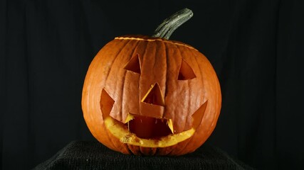 Stop motion, or time lapse, of a Halloween pumpkin being cut into a jack o' lantern. No grading applied, but a graded version is also available.