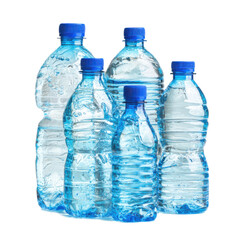 Row of six water bottles with blue caps