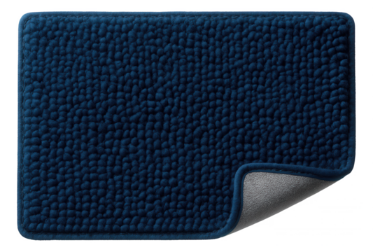 A chenille bath mat in a deep blue hue, adding a pop of color to a minimalist home bathroom.