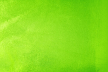 Yellow green lemon lime chartreuse abstract background. Light bright vivid vibrant metallic neon electric shade color. Toned surface of shiny fabric. Blank. Design.