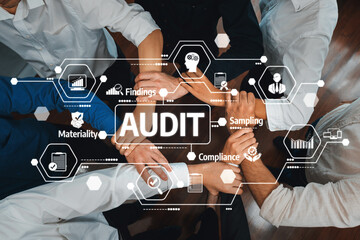 A top-down view of hands joined in collaboration for a financial audit process, emphasizing...