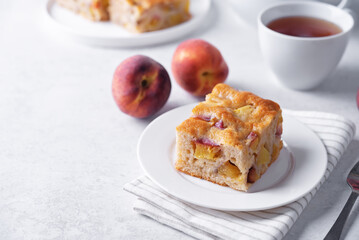 Peach cake with fresh peaches in the plate