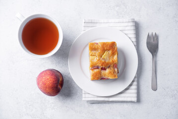 Peach cake with fresh peaches in the plate