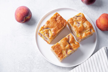 Peach cake with fresh peaches in the plate