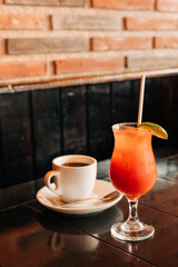 Colorful tropical drink and rich coffee served together at a cozy café during the afternoon