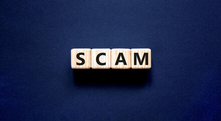 Scam symbol. Concept word Scam on beautiful wooden blocks. Beautiful black table black background....