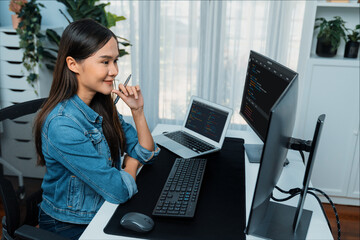 Young Asian IT developer looking online information on pc for beautiful pose with coding program...