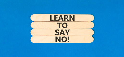 Learn to say no symbol. Concept words phrase Learn to say no on beautiful wooden stick. Beautiful blue paper background. Business psychological Learn to say no concept. Copy space.