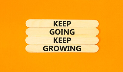 Keep going and growing symbol. Concept words phrase Keep going keep growing on beautiful wooden stick. Beautiful orange paper background. Business Keep going and growing concept. Copy space.