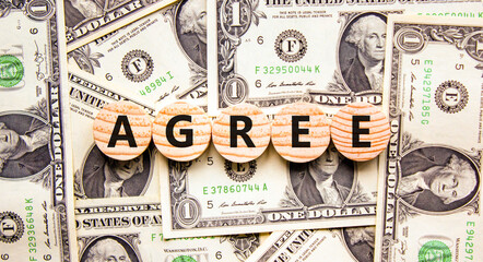 Agree symbol. Concept word Agree on beautiful wooden circles. Beautiful dollar bills. Beautiful background from dollar bills. Business agree concept. Copy space.