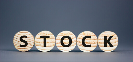 Stock symbol. Concept word Stock on beautiful wooden circles. Beautiful grey table grey background. Business lifestyle stock concept. Copy space.