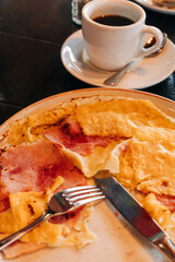Delicious breakfast featuring omelet with ham and a cup of coffee at a cozy cafe