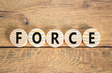 Force symbol. Concept word Force on beautiful wooden circles. Beautiful wooden table wooden background. Business lifestyle force concept. Copy space.