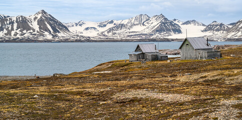 Fishing huts in Camp Mansfield overlook a beach in the Svalbard archipelago