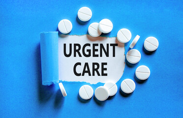 Urgent care symbol. Concept words Urgent care on beautiful white paper. White pills tablets. Beautiful blue background. Medical healthy lifestyle urgent care concept.