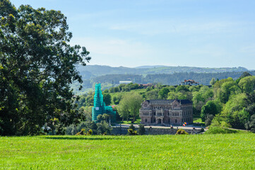 Historical Architecture Amidst Verdant Foliage in Comillas