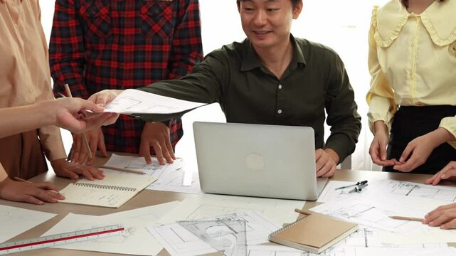 Architect and safety engineer celebrate success design building blueprint project on laptop with architectural document and measurement tool scatter around at modern office. Closeup. Delineation.