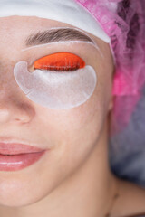 Caucasian woman undergoing eyelash lamination procedure. top view. 