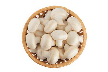Fresh mushroom champignon in a wicker basket isolated on white background. Top view. Flat lay