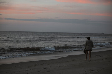 Lonely Woman Walking By the Florida Ocean at Sunset on a Peaceful Evening