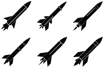 Black rockets with fins and exhaust flames ascending missile space