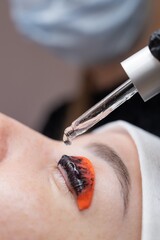 The process of professional lamination and tinting of eyelashes in the salon.
