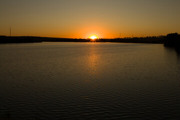 A body of water with a sunset