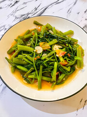 Stir-Fried Water Spinach with Garlic and Chili on a Plate