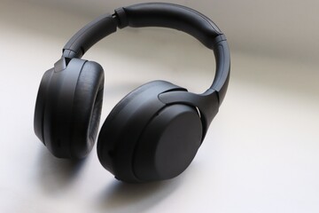 modern black wireless headphones on a white background as a symbol of mobility and technological choice