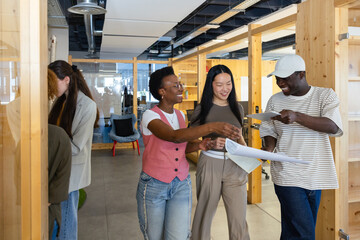 Collaborative team reviewing documents in dynamic office