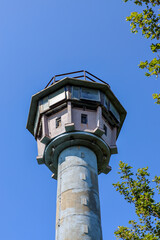 A former GDR watchtower stands as a stark reminder of Germany's divided past and the Cold War era.