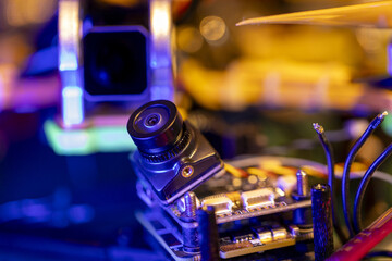 Close-up shot of 5-inch FPV drone camera and circuit board in vivid lighting