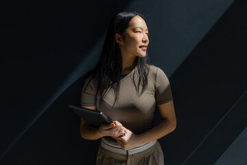 Young woman with a tablet in natural sunlight