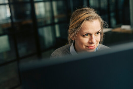 Smiling senior businesswoman working at office