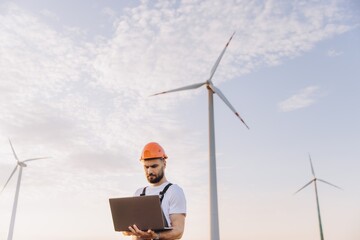 Engineer working with laptop in a wind turbine power plant