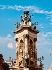 Historic baroque-style fountain at Plaça d’Espanya in Barcelona, featuring intricate sculptures,...