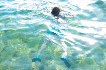 child swims in in open water, sea, confronting fear deep water and potential dangers drowning,...