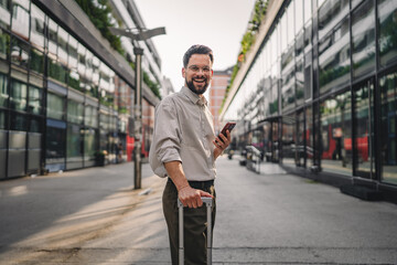 one man with beard and eyeglasses walk with suitcase and use phone