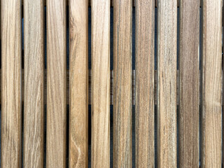 Natural wooden slats arranged in a parallel pattern showcasing rich textures and tones, ideal for...