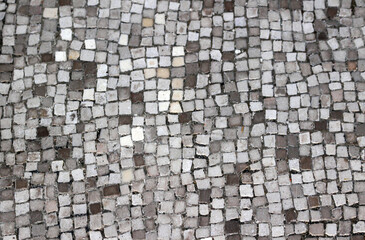 Small tiles mosaic pattern background design on a floor
