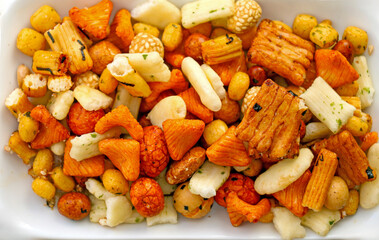 Pile of colorful rice crackers snacks in ceramic plate