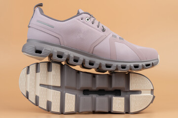 Stylish athletic shoes with unique design on neutral background