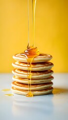 Stack of pancakes with honey syrup pouring down delicious breakfast food photography recipe idea