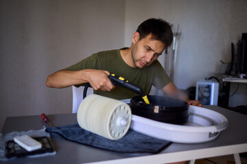 A man is utilizing a steam cleaner for effective home maintenance and cleanliness purposes