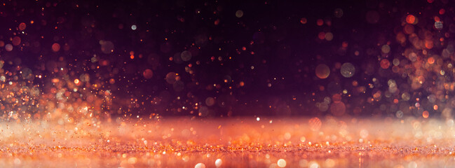 Sparkling dust creates a mesmerizing effect in a dark setting during a festive celebration