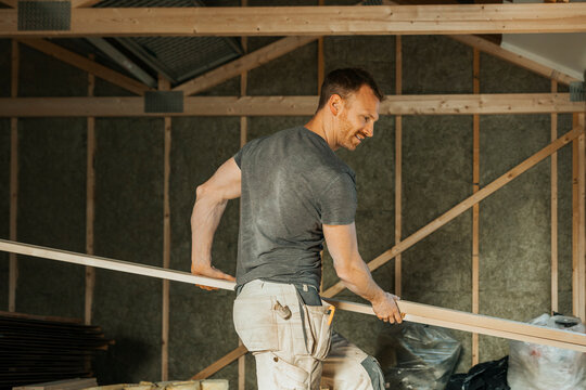 Mature male carpenter working at home renovation site